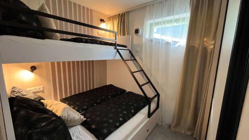 a bunk bed with a ladder in a room at apartmanhrabovob14 in Ružomberok