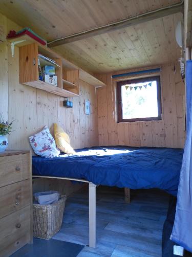 a bed in the inside of a tiny house at Schäferwagen Hotzenplotz 