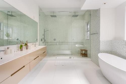 a white bathroom with a tub and a shower at Villa Roxi in Miami