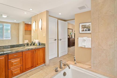 a bathroom with a tub and a sink at Makena Surf G-201 - End Unit, Panoramic Views, AC! in Wailea
