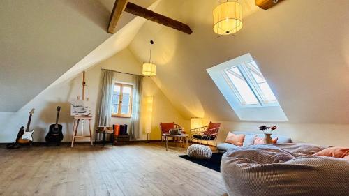 a living room with a couch and an attic at Der Hof am Wald in Weichselbaum