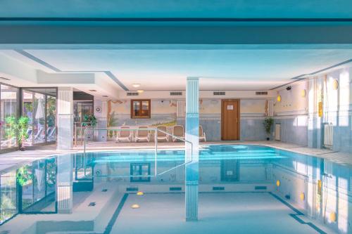 a pool in a building with a large at Hotel Garda Bellevue in Limone sul Garda