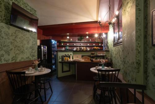 a restaurant with two tables and a counter in a kitchen at Walled off Hotel Paris in Paris