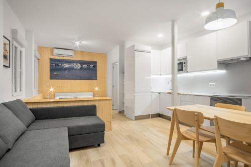 a living room with a couch and a table at 1 bedrooms 1 bathroom furnished - La Latina - modern - MintyStay in Madrid