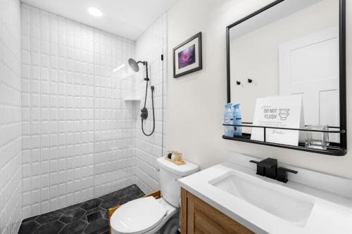 a bathroom with a sink and a toilet and a mirror at Smart Home in Heart of Snellville in Snellville