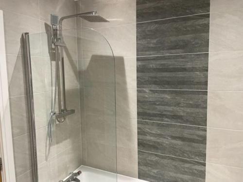 a shower with a glass door in a bathroom at Immaculate house in Doncaster 2 in Doncaster
