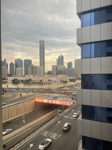 a view of a city with cars on a highway at Affordable Master Room - Core of Abu Dhabi in Abu Dhabi