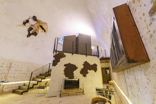 a man is jumping off of a wall in a room at Il Granile Contemporary Loft in Matera