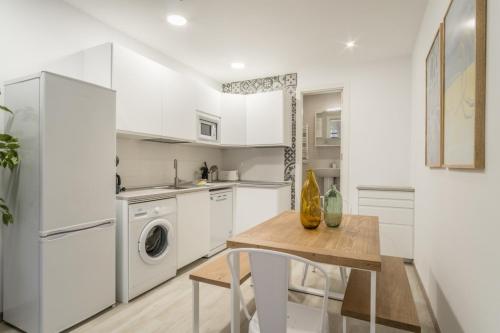 a kitchen with a table and a washer and dryer at Modern- 1 Bd 1,5 Bth- Delicias Atocha in Madrid