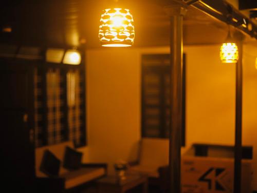 a room with two lights on the wall at Paroommel Haven Wayanad in Kenichira
