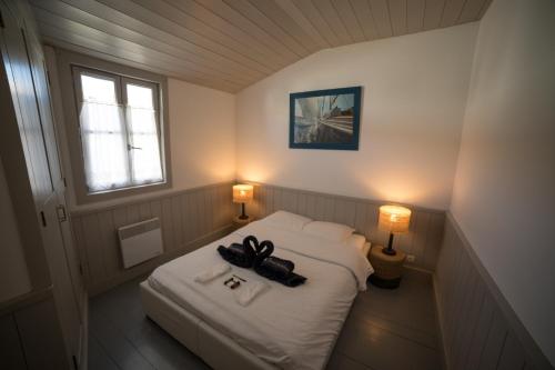 Cette petite chambre dispose d'un lit avec deux lumières allumées. dans l'établissement Villa Green Oaks, à Rivedoux-Plage
