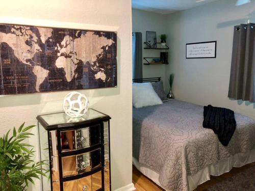 a bedroom with a bed and a map on the wall at Downtown Dunedin! 2 bedroom 2 bath NO PETS in Dunedin