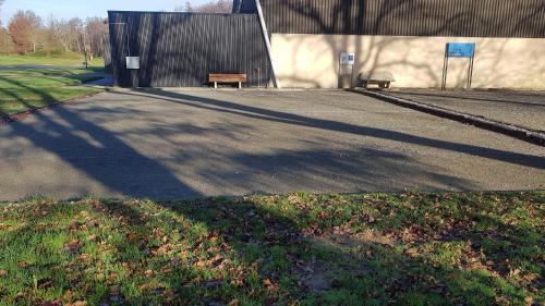 a street with a bench in front of a building at Le Genest St Isles in Le Genest