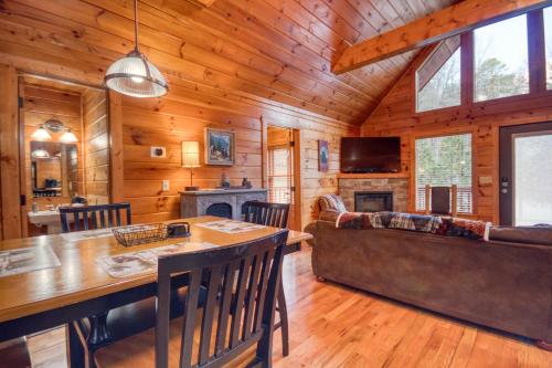 a dining room and living room in a log cabin at Long Overdue in Pigeon Forge