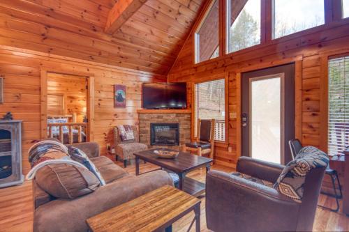 a living room with couches and a fireplace in a log cabin at Long Overdue in Pigeon Forge