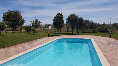 a swimming pool in the middle of a park at Quinta da Paz in Borba