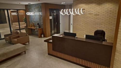 a lobby with a hair salon with a reception desk at Hotel Mãe Morena in Aparecida