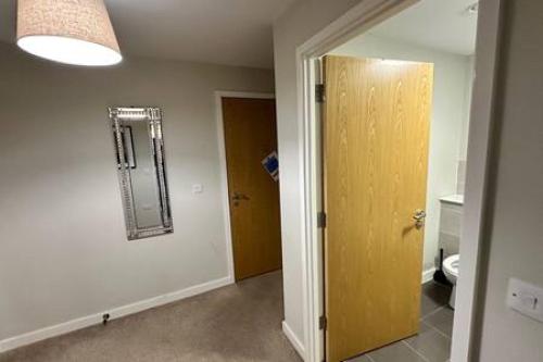 a bathroom with a toilet and a mirror on the wall at Cosy 1 Bed Central Manchester Apartment Sleeps 2 in Manchester