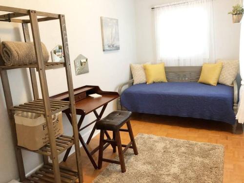 a living room with a bed and a ladder at Overlooking Downtown Dunedin Two Bedroom apartment NO KIDS, NO PETS in Dunedin