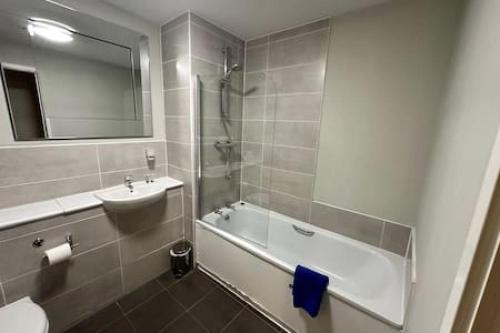 a bathroom with a sink and a tub and a toilet at Fab 1 Bed Apartment with Balcony and River Views Sleeps 2 in Manchester
