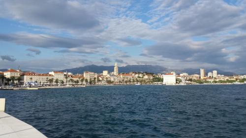 a view of a city from a body of water at Apartment Marinis in Split