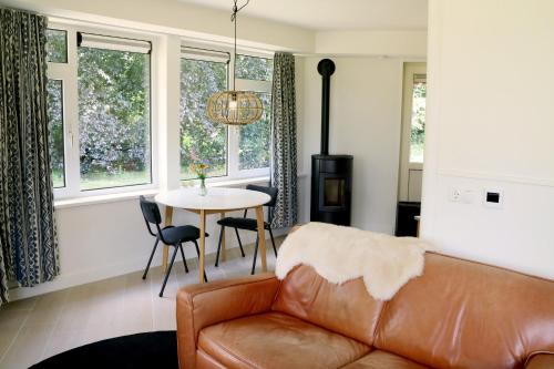 een woonkamer met een bank en een tafel bij Eco Lodge Drenthe in Valthe