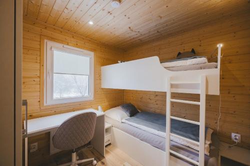 a room with two bunk beds and a desk at Apartmán Andrea in Červená Voda