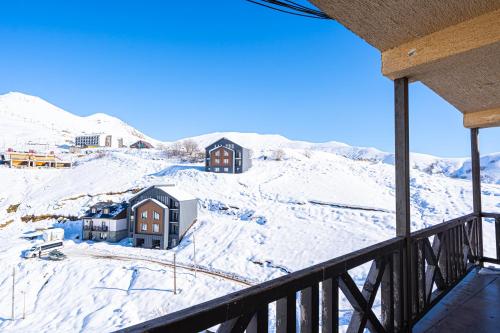 a view of a snow covered mountain from a balcony at 2-room Apartment Gudauri Penta 703 in Gudauri
