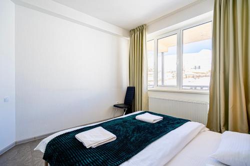 a bedroom with a bed and a large window at 2-room Apartment Gudauri Penta 703 in Gudauri