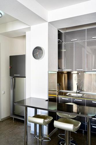 a kitchen with a black counter and stools in it at 2-room Apartment Gudauri Penta 703 in Gudauri