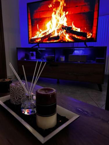 a living room with a fire in a fireplace at Pyrgi Village apartment in Pyrgi