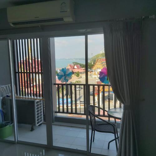 a room with a balcony with a view of the ocean at Apartment in Bang Saray center with panoramic view from sea to mountains in Bang Sare