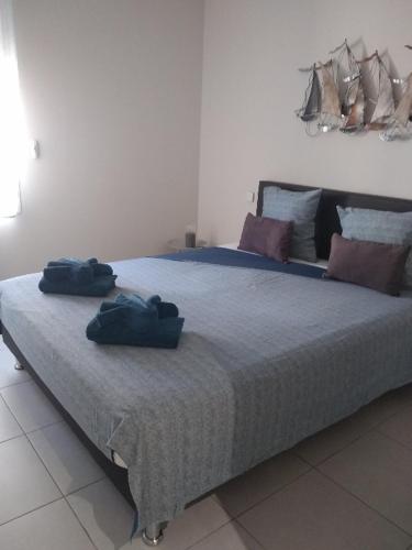 - un grand lit avec 2 serviettes bleues dans l'établissement LES POISSONS, à Sète