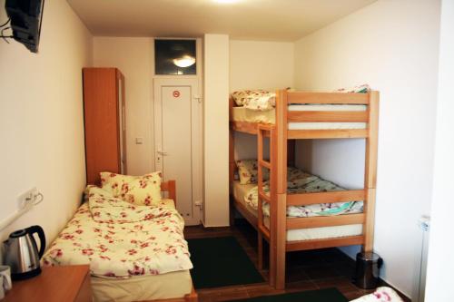 a small room with two bunk beds and a desk at Hostel Mak in Sarajevo
