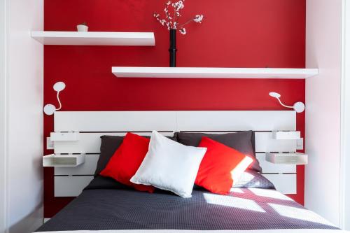 a red bedroom with a bed with red walls at Villa Bice in Bergeggi