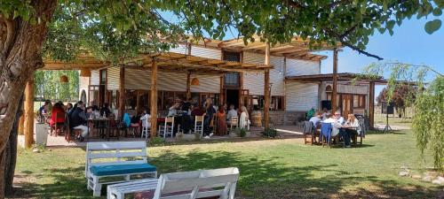 un groupe de personnes assis à des tables à l'extérieur d'un bâtiment dans l'établissement Finca La Valletana, à Vista Flores