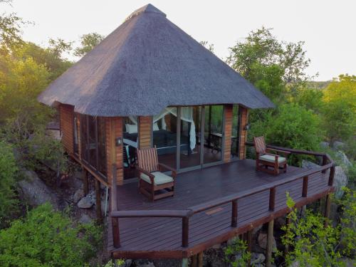 a gazebo with chairs and a roof at Parsons House in Hoedspruit