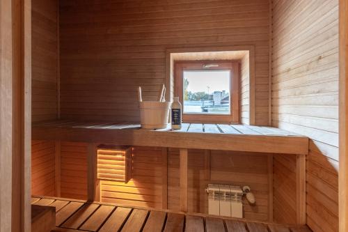a sauna with a window in a wooden cabin at HermiinStay - apartment with sauna and hot tub in Tartu