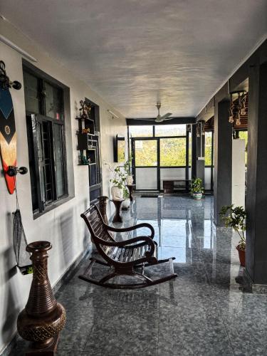 a living room with a bench in the middle at Karvaan B&B - 2bhk Homestay in Pālampur