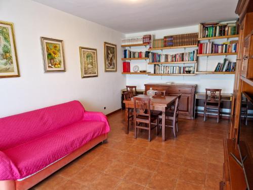 a living room with a red couch and a table at DOMUS DIVI - Eur Torrino in Rome