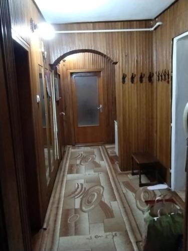 a hallway with a tile floor in a room with a door at DAION in Bistriţa