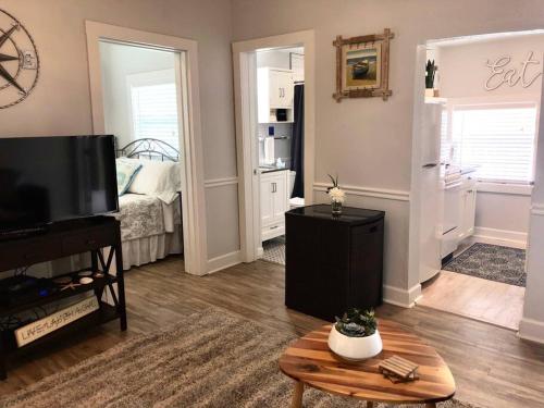 a living room with a television and a bed at In the Heart of Downtown Dunedin One Bedroom Apt NO KIDS, NO PETS in Dunedin