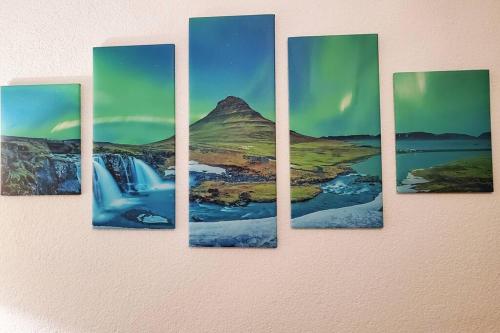 a painting of a mountain on a wall at Terrassenwohnung Nordlicht in Grimma