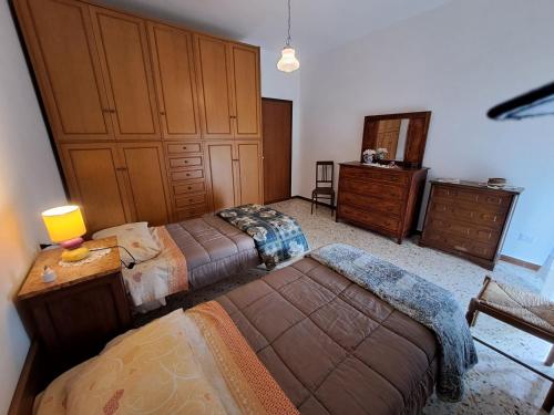 a bedroom with two beds and a dresser at CASA VACANZE L'OLIVO in Lubriano