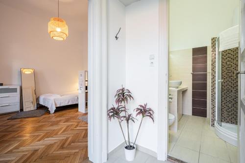 a bathroom with a potted plant in a room at Elementa Luxe Apartment in Budapest