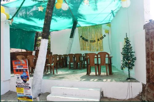 eine Bühne mit Stühlen und ein Weihnachtsbaum darauf in der Unterkunft KonkanParadise,Hotel Malvan Beach in Malvan
