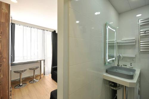 a bathroom with a sink and a mirror at Pazuzu Top View in Gudauri