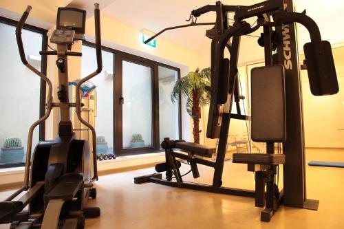 a gym with two exercise bikes in a room at relexa hotel Stuttgarter Hof in Berlin