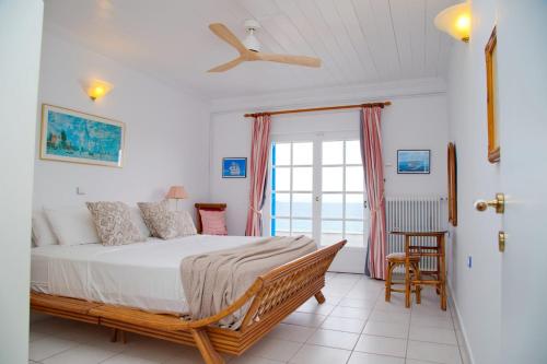 A bed or beds in a room at Aroura Homes 4BR Beachfront Villa