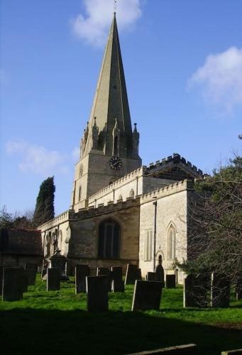 an old church with a steeple and a cemetery at Pinewood #Edwinstowe in Edwinstowe